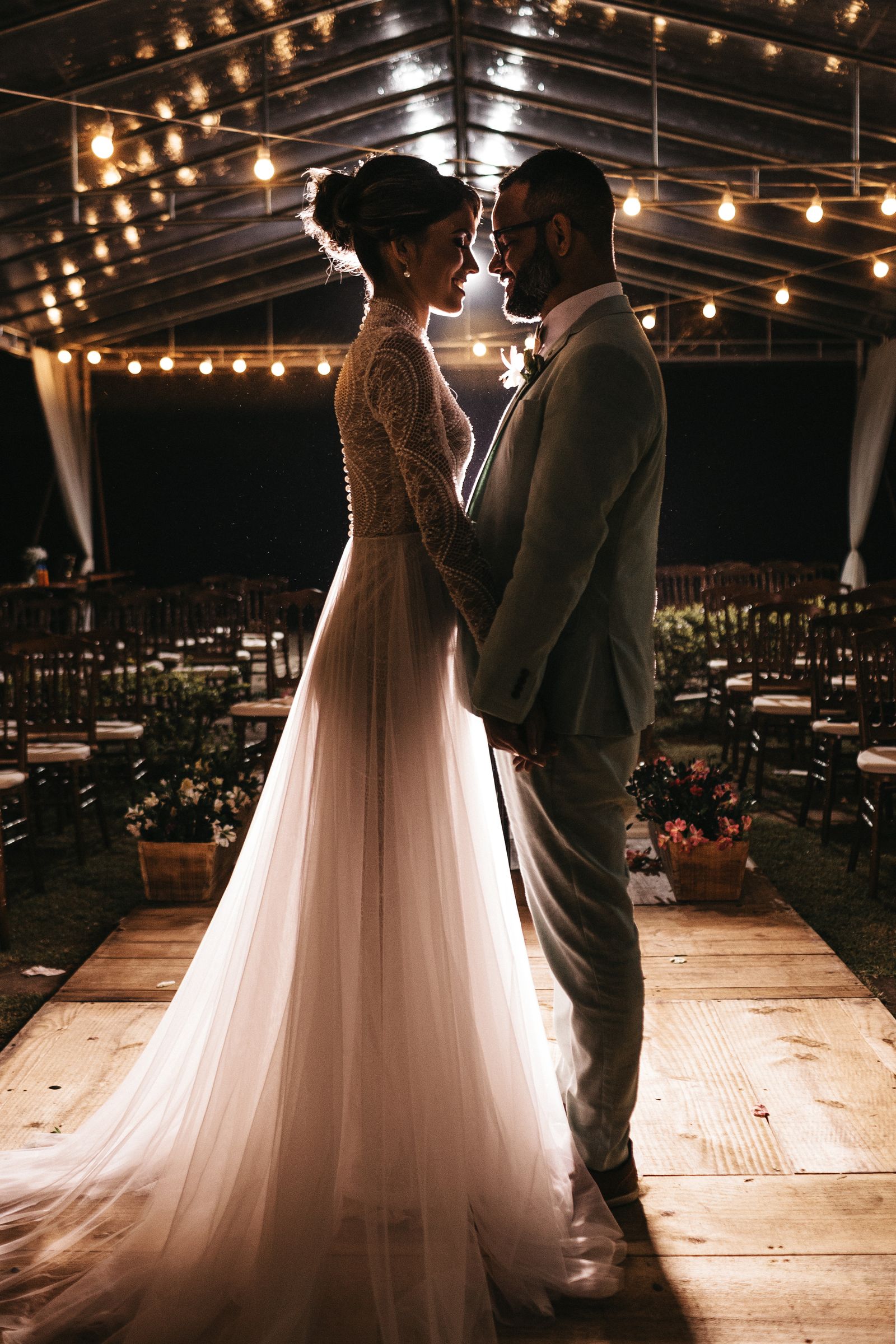 Couple de mariés sous les guirlandes lumineuses du domaine